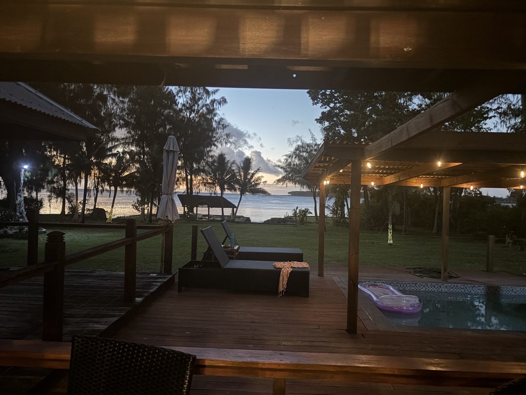 The deck at dusk with festoon lights and the sea beyond