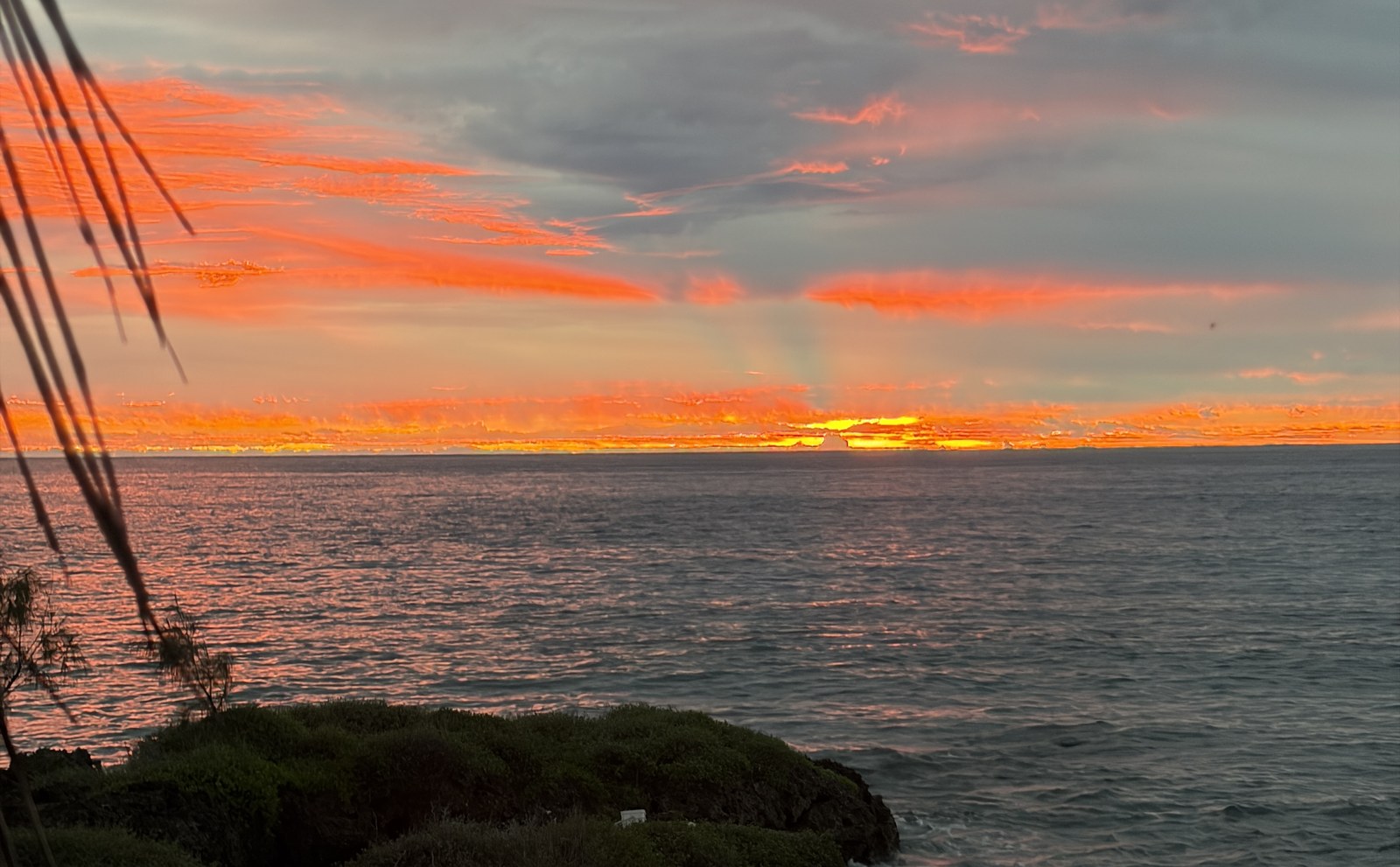 Sunset over the lagoon from the lawn at Coral Sunset